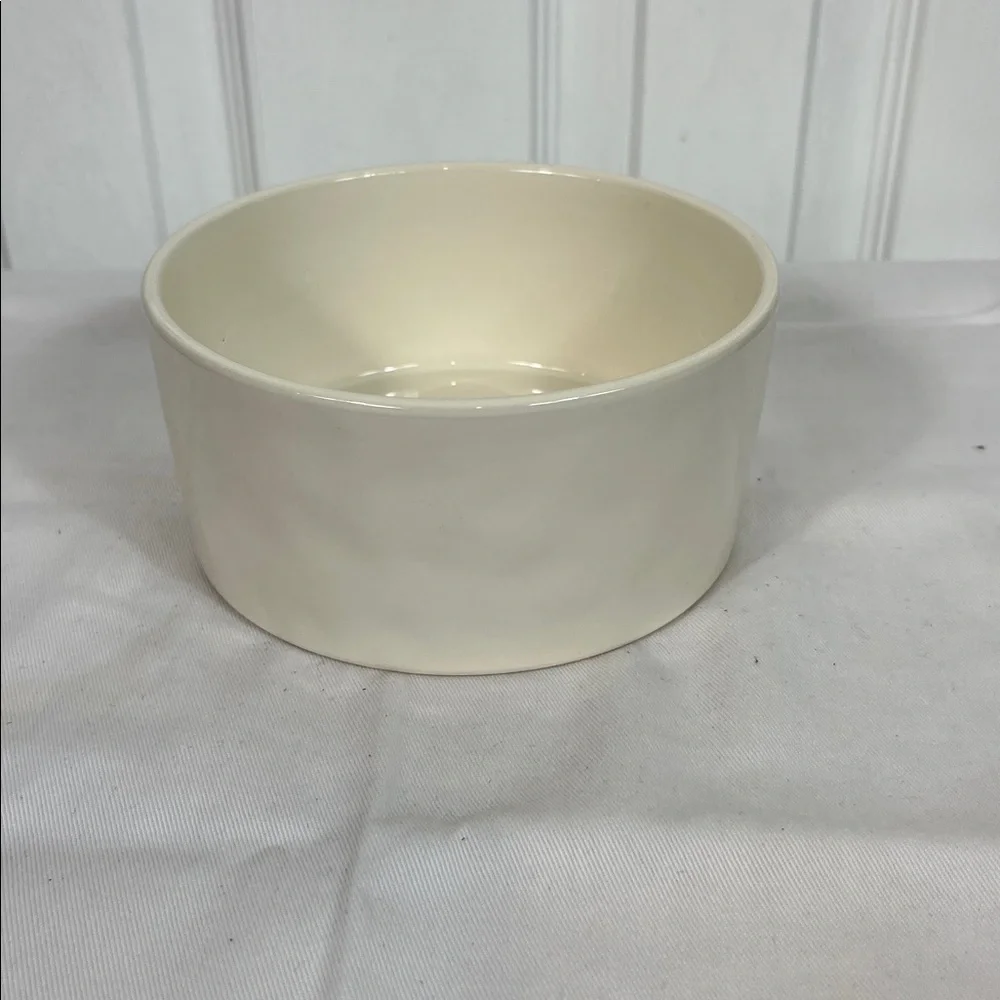 NWOT Rae Dunn white dog bowl 6”wide, 3”tall. Stick on front, WOOF inside bottom